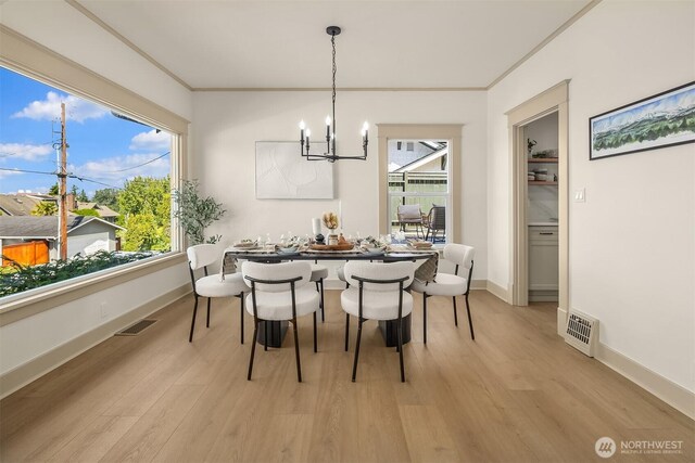 702 34th St, Everett, WA 98201 - dining room featuring a chandelier, light wood finished floors, and crown molding