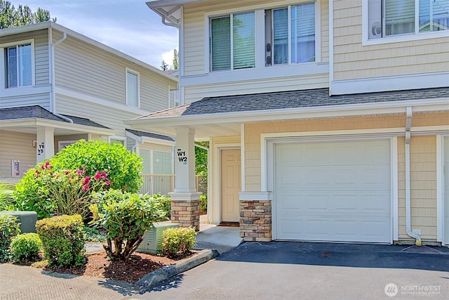 14007 69th Dr SE Unit W2, Snohomish, WA 98296 - property entrance with an attached garage, roof with shingles, and asphalt driveway
