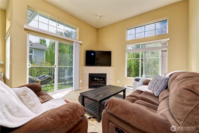 14007 69th Dr SE Unit W2, Snohomish, WA 98296 - carpeted living room featuring plenty of natural light, a tiled fireplace, and a high ceiling