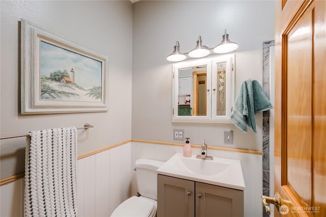 2595 Anderson Hill Rd SW, Port Orchard, WA 98367 - half bathroom featuring a wainscoted wall and vanity