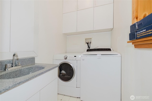 2595 Anderson Hill Rd SW, Port Orchard, WA 98367 - laundry room featuring washer and clothes dryer, cabinet space, and light tile patterned floors