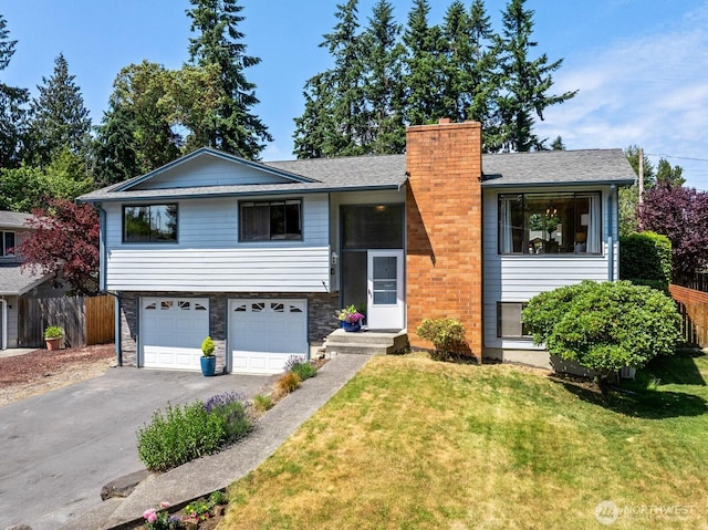 8815 221st Pl SW, Edmonds, WA 98026 - bi-level home with asphalt driveway, a garage, and a chimney