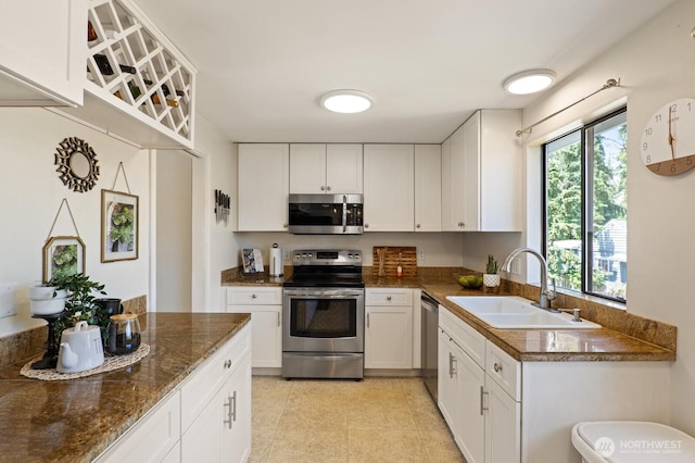 8815 221st Pl SW, Edmonds, WA 98026 - kitchen with appliances with stainless steel finishes, white cabinetry, light tile patterned flooring, and dark stone countertops