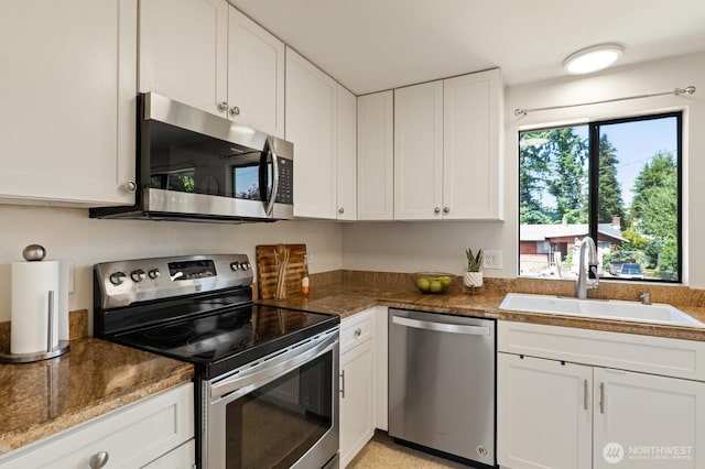 8815 221st Pl SW, Edmonds, WA 98026 - kitchen with stainless steel appliances, white cabinetry, and dark stone counters