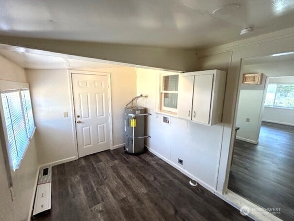 1004 8th, Longview, WA 98632 - laundry room with secured water heater, dark wood-style flooring, and hookup for a washing machine