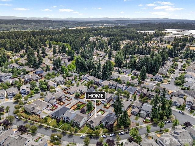 9127 Periwinkle Loop NE, Olympia, WA 98516 - aerial overview of property's location with a forest and nearby suburban area