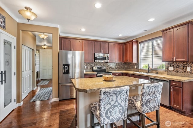 9127 Periwinkle Loop NE, Olympia, WA 98516 - kitchen featuring stainless steel appliances, tasteful backsplash, a breakfast bar, a center island, and light countertops