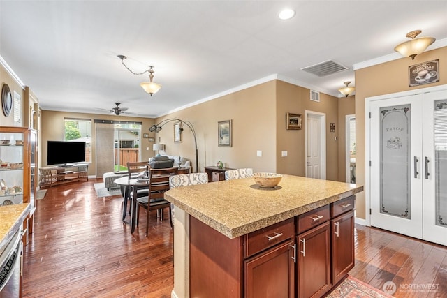 9127 Periwinkle Loop NE, Olympia, WA 98516 - kitchen with french doors, a ceiling fan, crown molding, light countertops, and hardwood / wood-style flooring