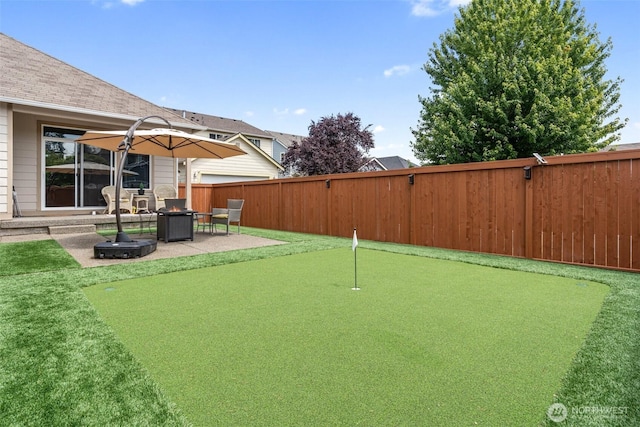9127 Periwinkle Loop NE, Olympia, WA 98516 - fenced backyard with a putting green and a patio area