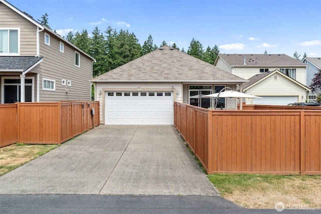 9127 Periwinkle Loop NE, Olympia, WA 98516 - view of front of house with a shingled roof, driveway, and an attached garage