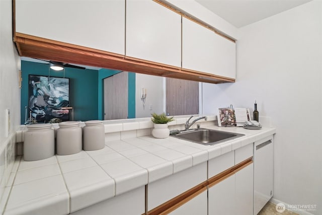 7000 Cleopatra Pl NW Unit 303, Seattle, WA 98117 - kitchen with white cabinets, white dishwasher, and ceiling fan