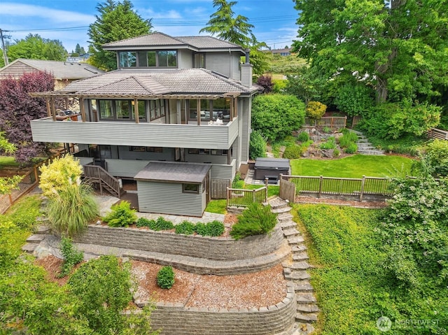 9201 24th Ave NW, Seattle, WA 98117 - rear view of property with stairs, a jacuzzi, a sunroom, a storage shed, and a fenced backyard