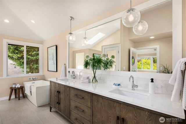 9201 24th Ave NW, Seattle, WA 98117 - full bath featuring double vanity, a skylight, lofted ceiling, a freestanding tub, and recessed lighting