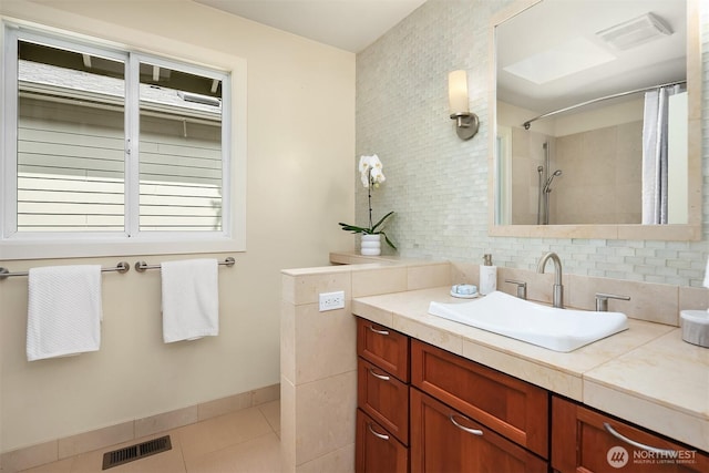 9201 24th Ave NW, Seattle, WA 98117 - full bath featuring vanity, decorative backsplash, tiled shower, and tile patterned floors