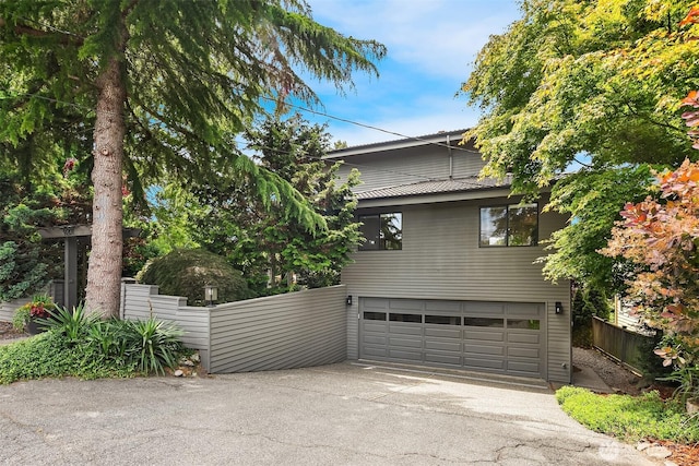9201 24th Ave NW, Seattle, WA 98117 - view of property exterior with an attached garage and concrete driveway