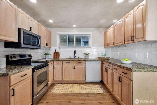 3109 N 7th St, Tacoma, WA 98406 - kitchen featuring appliances with stainless steel finishes, light brown cabinets, light wood-style floors, recessed lighting, and tasteful backsplash