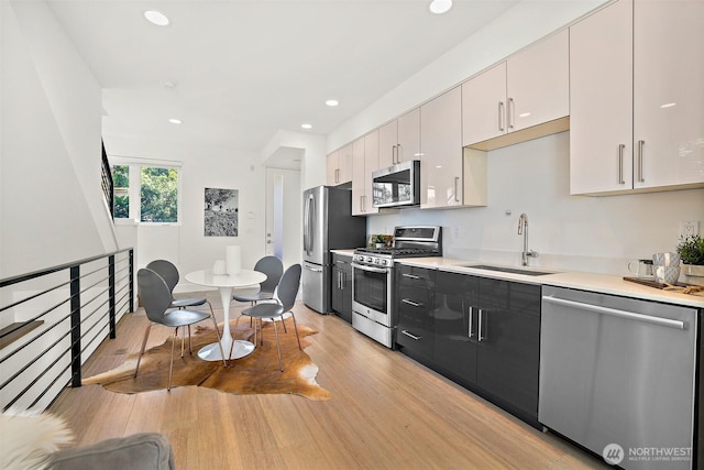 1513 Lakeview Blvd E, Seattle, WA 98102 - kitchen with stainless steel appliances, light wood finished floors, light countertops, and recessed lighting