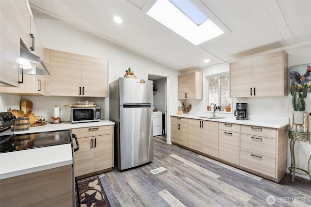 725 37th St SE Unit 36, Auburn, WA 98002 - kitchen featuring light brown cabinets, freestanding refrigerator, electric stove, extractor fan, and lofted ceiling