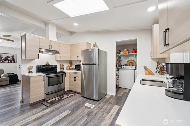 725 37th St SE Unit 36, Auburn, WA 98002 - kitchen with stainless steel appliances, washer / dryer, under cabinet range hood, light brown cabinetry, and light countertops
