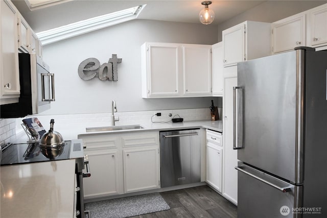 2010 Waverly Pl N, Seattle, WA 98109 - kitchen with stainless steel appliances, dark wood-type flooring, light countertops, white cabinetry, and backsplash