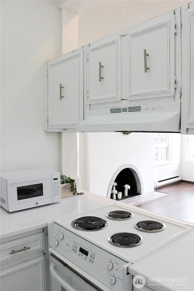 2010 Waverly Pl N, Seattle, WA 98109 - kitchen with white appliances, under cabinet range hood, and light countertops