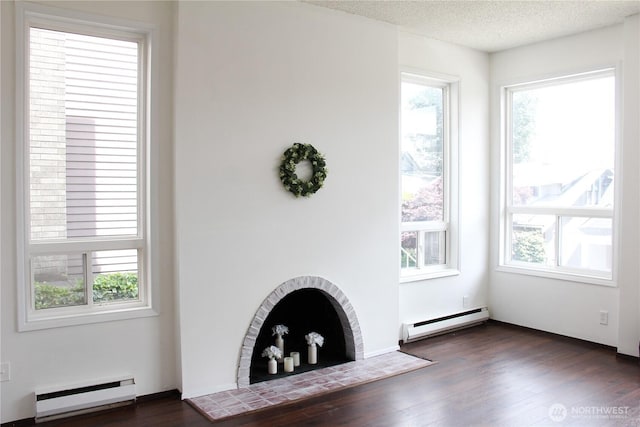 2010 Waverly Pl N, Seattle, WA 98109 - unfurnished living room with a baseboard radiator, dark wood finished floors, and a textured ceiling