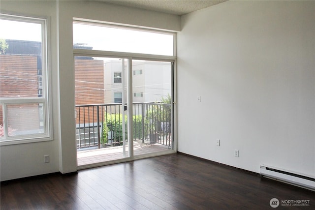 2010 Waverly Pl N, Seattle, WA 98109 - empty room with a baseboard radiator and dark wood-style flooring