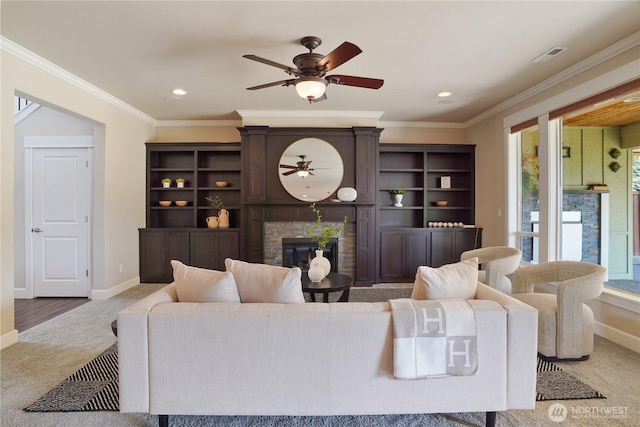 11214 172nd Street Ct E, Puyallup, WA 98374 - carpeted living room with ceiling fan, a stone fireplace, ornamental molding, and recessed lighting