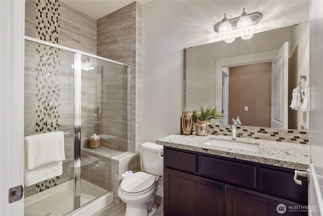 11214 172nd Street Ct E, Puyallup, WA 98374 - bathroom featuring vanity, decorative backsplash, and a stall shower