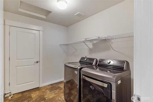 11214 172nd Street Ct E, Puyallup, WA 98374 - washroom featuring washing machine and dryer, attic access, and stone finish flooring