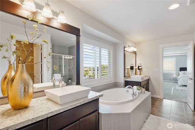 11214 172nd Street Ct E, Puyallup, WA 98374 - full bath with a shower stall, healthy amount of natural light, a bath, two vanities, and recessed lighting