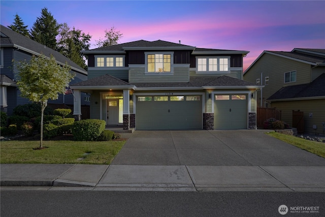 11214 172nd Street Ct E, Puyallup, WA 98374 - view of front of home featuring a garage, concrete driveway, a front lawn, stone siding, and a shingled roof