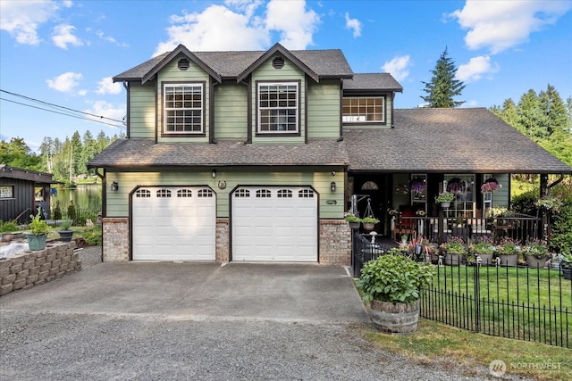 32421 Whitman Lake Dr E, Graham, WA 98338 - view of front of house with an attached garage, covered porch, driveway, and brick siding