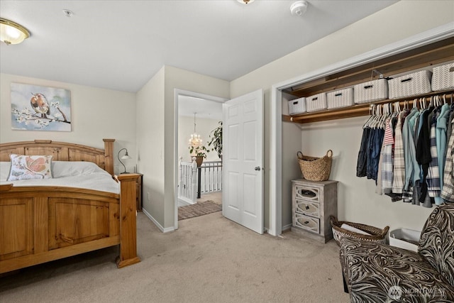 32421 Whitman Lake Dr E, Graham, WA 98338 - bedroom with light colored carpet, a closet, and a chandelier