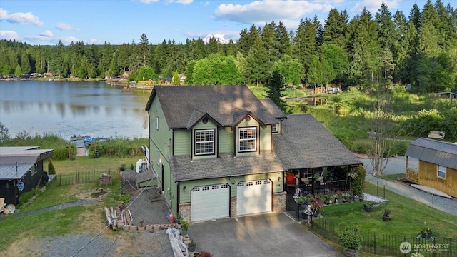 32421 Whitman Lake Dr E, Graham, WA 98338 - view of front of house with an attached garage, a water view, driveway, a forest view, and roof with shingles