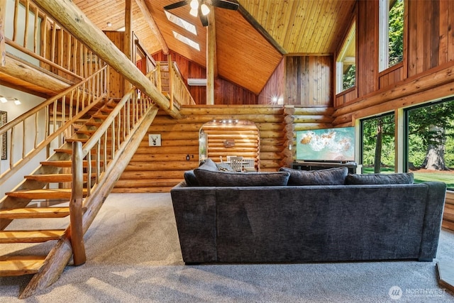 8209 271st Ave E, Buckley, WA 98321 - carpeted living area with high vaulted ceiling, stairs, rustic walls, wood ceiling, and ceiling fan