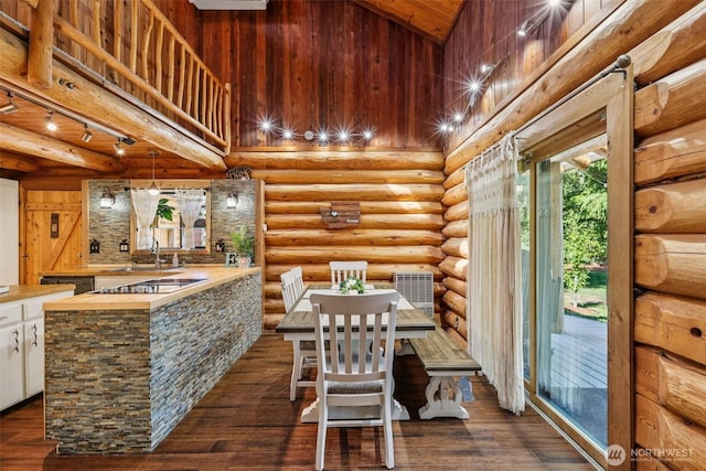 8209 271st Ave E, Buckley, WA 98321 - dining area featuring high vaulted ceiling and dark wood-type flooring