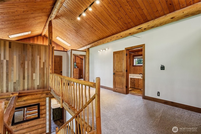 8209 271st Ave E, Buckley, WA 98321 - hall featuring an upstairs landing, wood ceiling, carpet floors, a skylight, and track lighting