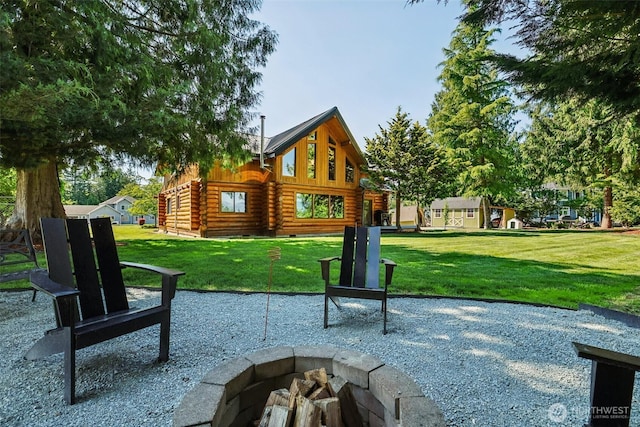 8209 271st Ave E, Buckley, WA 98321 - rear view of property with a fire pit, log siding, a patio area, and a lawn