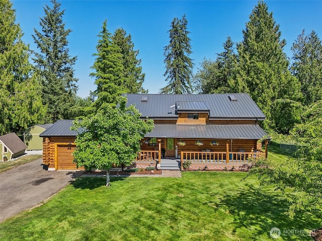 8209 271st Ave E, Buckley, WA 98321 - log-style house with log siding, a porch, a front lawn, and asphalt driveway