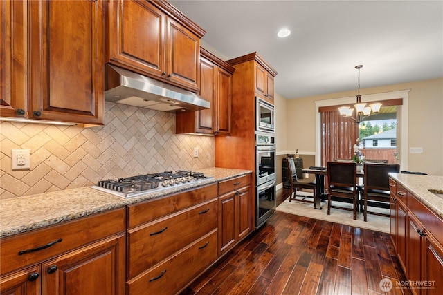 4837 Castleton Rd SW, Port Orchard, WA 98367 - kitchen with appliances with stainless steel finishes, under cabinet range hood, dark wood-style flooring, backsplash, and recessed lighting