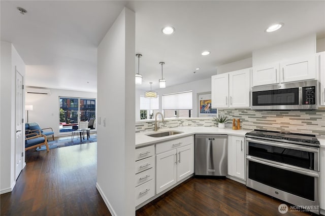 4026 Stone Way N Unit 501, Seattle, WA 98103 - kitchen with stainless steel appliances, light countertops, tasteful backsplash, white cabinets, and recessed lighting
