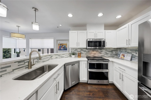 4026 Stone Way N Unit 501, Seattle, WA 98103 - kitchen featuring appliances with stainless steel finishes, decorative backsplash, decorative light fixtures, white cabinetry, and recessed lighting