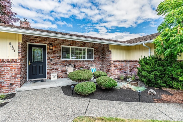 6301 Agnes Rd NE, Tacoma, WA 98422 - view of exterior entry featuring brick siding and a chimney