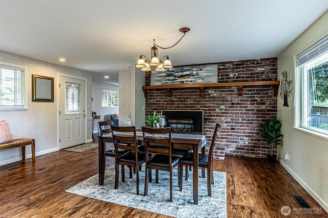 6301 Agnes Rd NE, Tacoma, WA 98422 - dining space featuring wood finished floors, a chandelier, and a fireplace