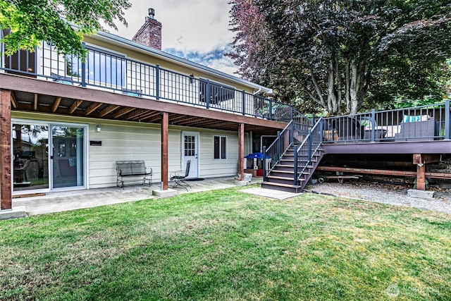 6301 Agnes Rd NE, Tacoma, WA 98422 - back of property featuring a patio area, a wooden deck, stairs, a lawn, and a chimney