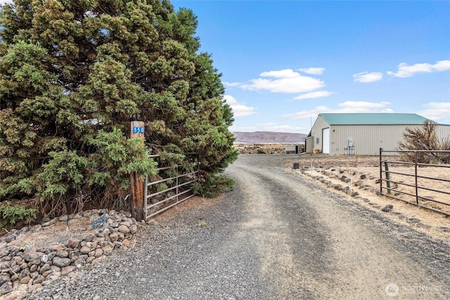 550 Red Tail Rd, Yakima, WA 98908 - view of dirt / gravel road featuring a pole building and a gated entry