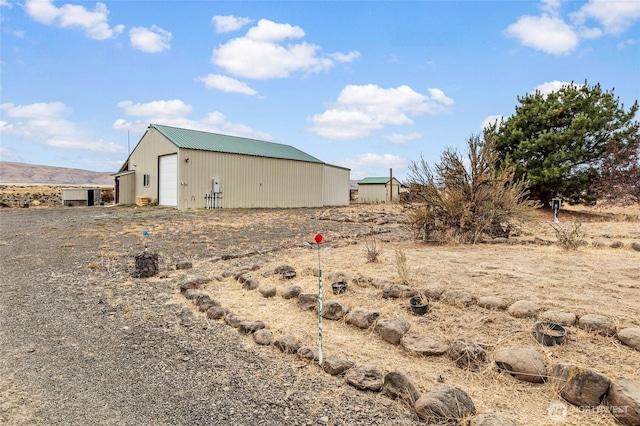 550 Red Tail Rd, Yakima, WA 98908 - view of yard featuring a detached garage, an outdoor structure, and an outbuilding