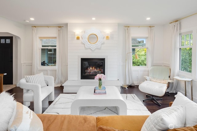 3249 27th Ave W, Seattle, WA 98199 - living area with wood finished floors, a decorative wall, recessed lighting, arched walkways, and a fireplace