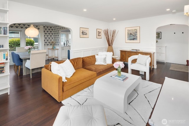 3249 27th Ave W, Seattle, WA 98199 - living room with arched walkways, wood finished floors, recessed lighting, and wainscoting
